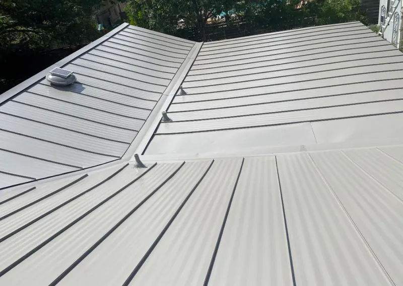 Solar attic fan installed on a metal roof for Roof Ventilation in South Kensington